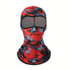 A red and black camouflage balaclava cap worn by a person.