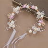 Elegant floral wreath headband featuring pink and white flowers and pearl accents