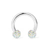 A set of crystal horseshoe barbell rings made of surgical steel.