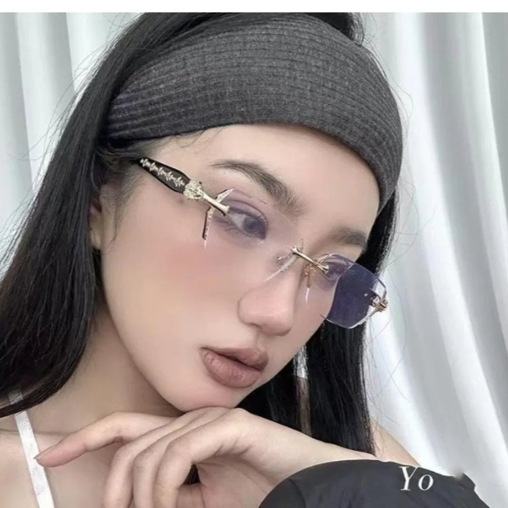 A close-up of a woman wearing vintage Y2K frameless glasses with purple lenses and a black headband.