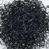 A pile of black disposable hair scrunchies for ponytail holders.