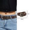 A dark brown leather belt with silver bullet studs is shown worn on a denim shirt.