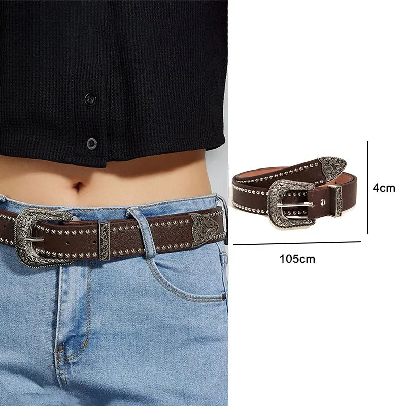 A dark brown leather belt with silver bullet studs is shown worn on a denim shirt.