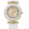 A white quartz wristwatch with a gold-toned case, glitter dial, and white strap.