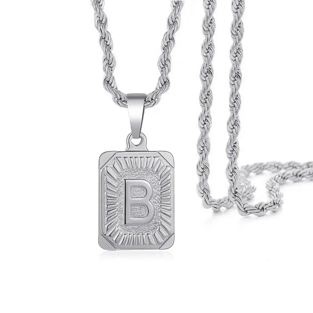 A silver letter B pendant necklace with a chain, featuring an engraved design.