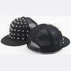 Black flat hat baseball cap with silver rivets and mesh fabric.