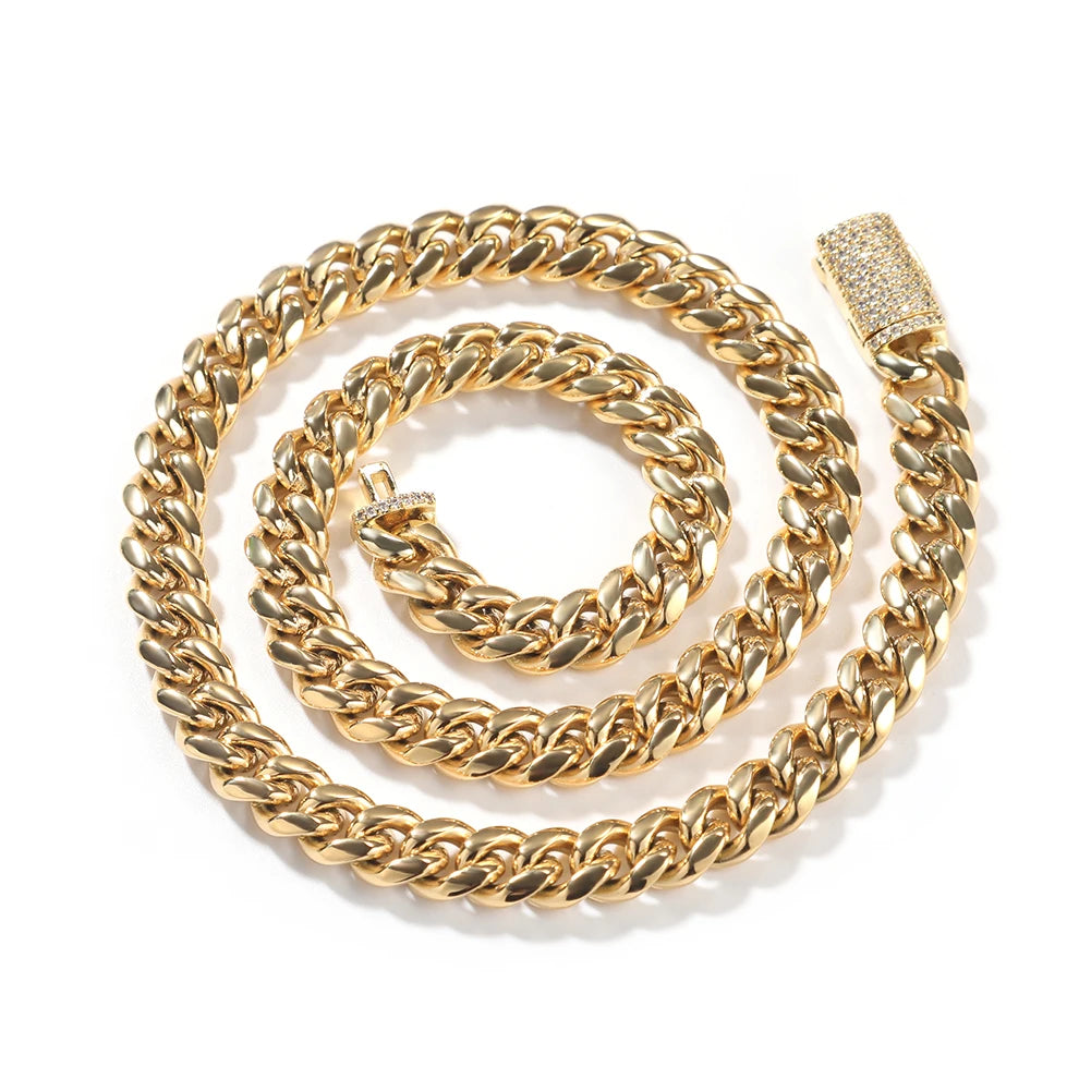 A gold stainless steel Cuban link necklace coiled in a circular pattern with a diamond accent clasp.