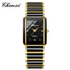 A black and gold luxury quartz watch with a black dial and gold accents on a black strap.
