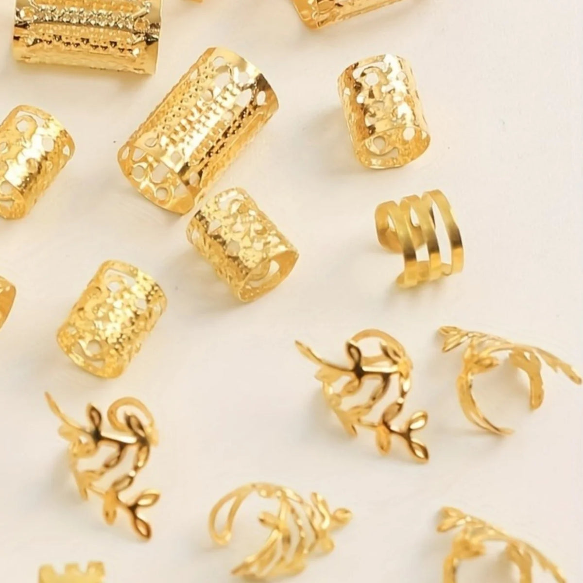 A collection of elegant gold hollow hair rings and braiding accessories.