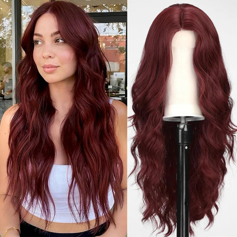 A woman models a long, wavy red wine colored synthetic wig with dark red hair.