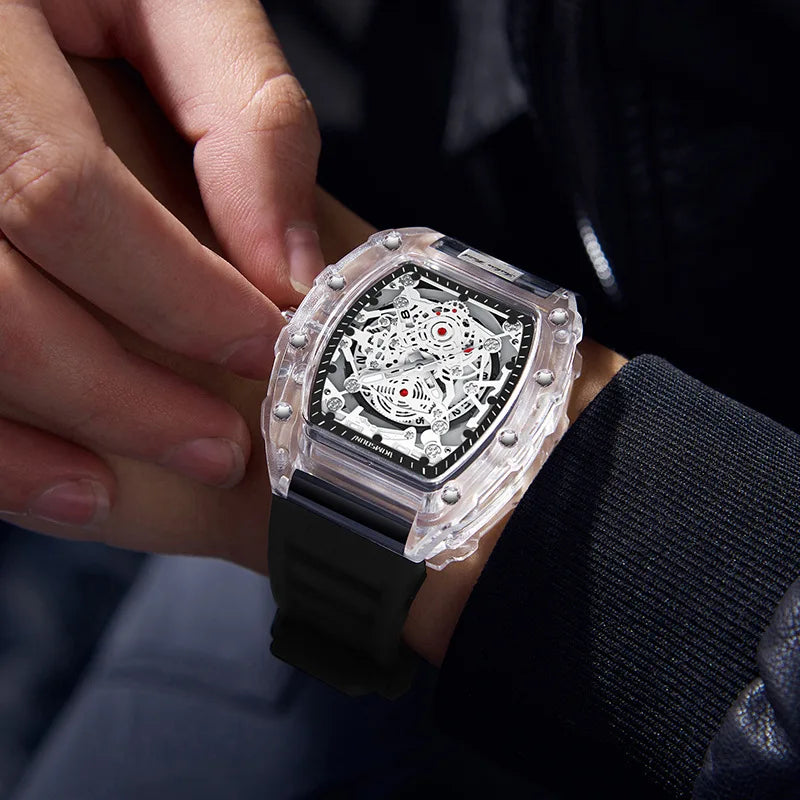 A hand is holding a black quartz watch with a clear crystal and silver dial on a wrist.