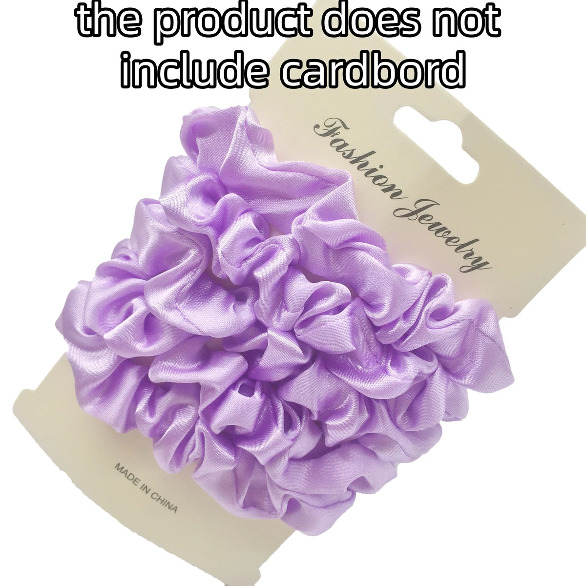 A purple satin hair scrunchies set is displayed on a cardboard tag.