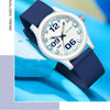 A white and blue analog watch with a dark blue silicone strap is shown on a light blue surface.