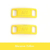 Two yellow AF1 diamond shoe charms or laces against a white background.