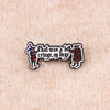 An enamel pin featuring text that was a cringe my liege in a vintage style