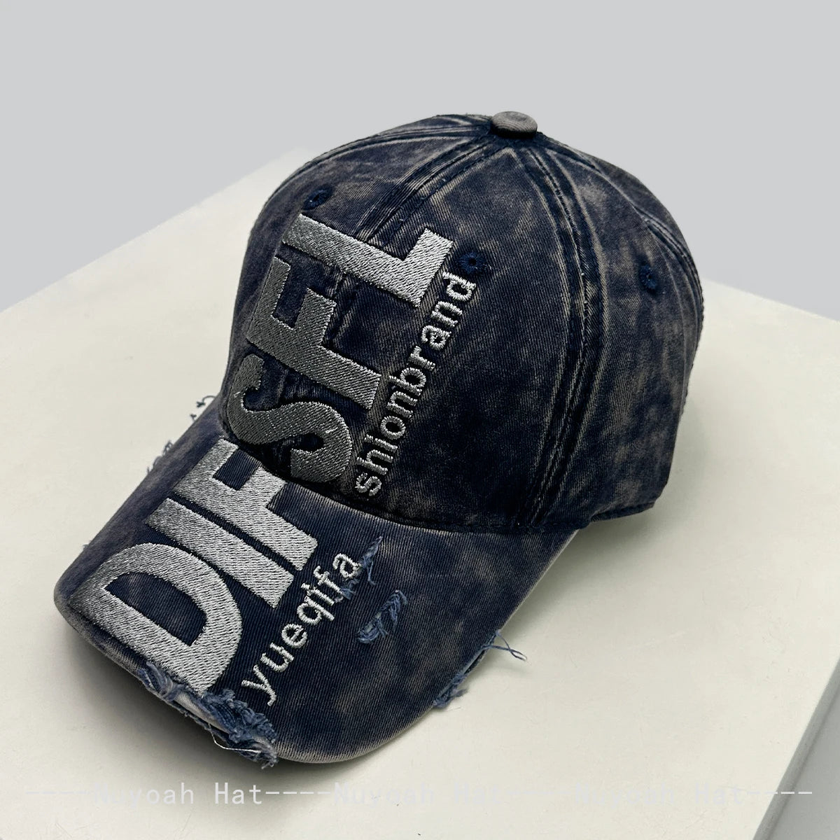 A dark denim baseball cap embroidered with the letters DISFL and the word shionbrand