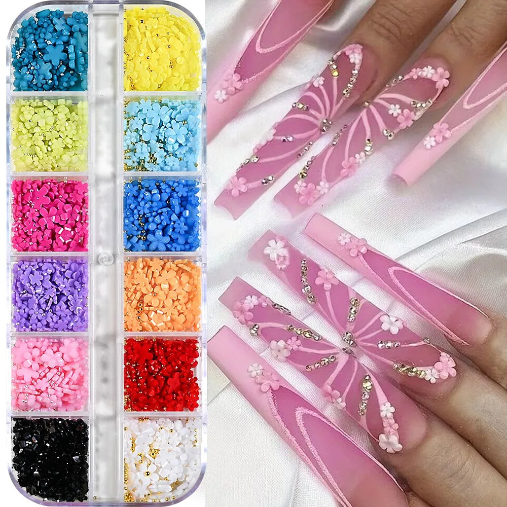 A collection of pink and white butterfly bow nail charms in various colors displayed on a hand.