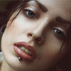 Close-up portrait of a woman wearing stainless steel labret lip rings.