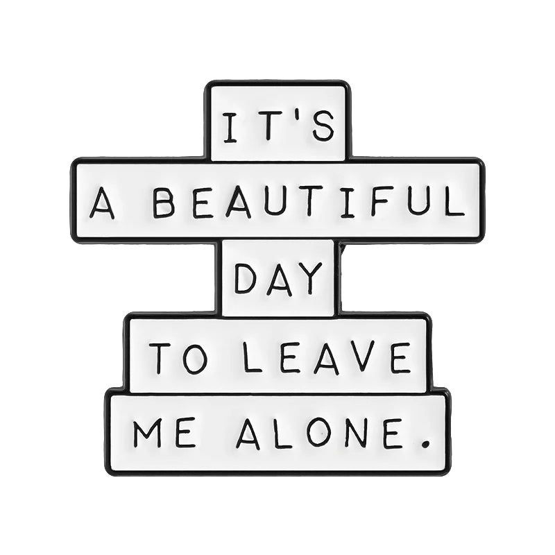 An enamel pin featuring the quote It's a beautiful day to leave me alone.