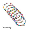 A set of thin, colorful resin beaded bracelets arranged in a spiral pattern.