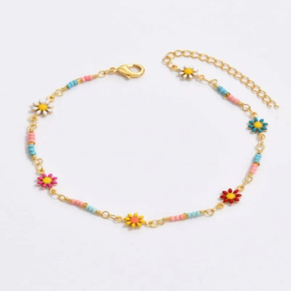 Gold daisy chain anklet for women featuring small floral charms and colorful beads.