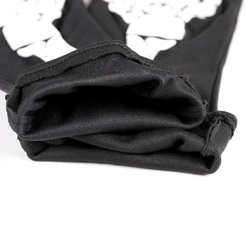 Black gloves with a white skeleton pattern folded and displayed