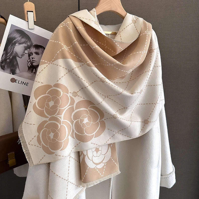 A beige and cream luxury plaid cashmere feel scarf and shawl wrap draped over a light colored coat.