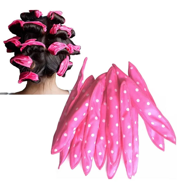 A set of ten pink flexible hair curling rollers with white polka dots