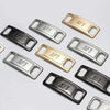 A collection of gold and silver metal shoe charms and laces marked with the letters AF1