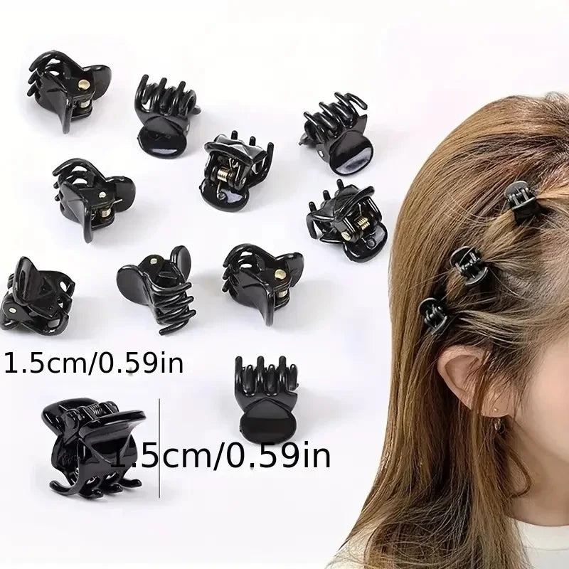 A set of black adjustable hair claw clips shown with various sizes and angles against a white background.