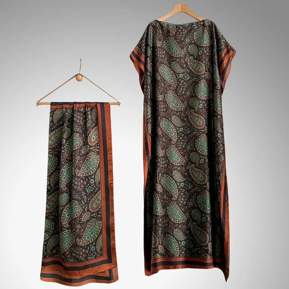 A dark patterned cape shawl featuring floral butterfly and peacock motifs with orange trim.