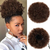 A close-up of a woman wearing a kinky drawstring ponytail extension, showing the texture and volume of the hair.