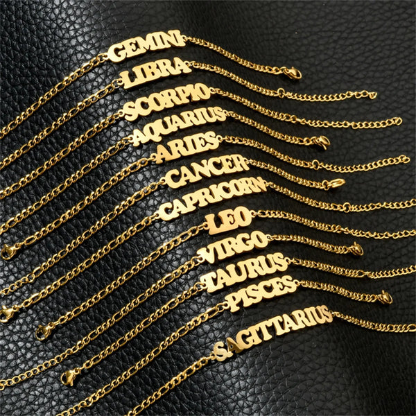 A collection of gold stainless steel charm bracelets featuring zodiac constellation names like Gemini, Libra, Scorpio, and Le