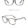 A pair of tortoiseshell patterned, retro square eyeglasses shown from the front and side views.