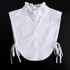 White blouse with a ruffled false collar and tie details.