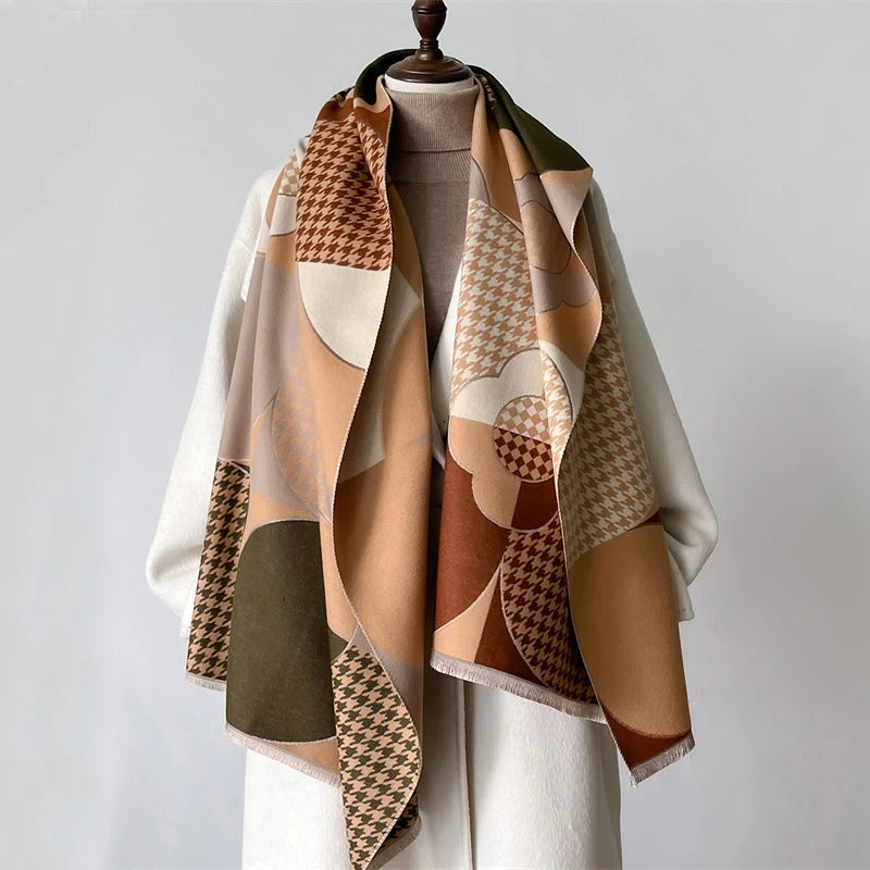 A beige and brown plaid cashmere scarf draped over a mannequin.