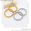 Three gold and silver stainless steel elastic bangle bracelets displayed on a white background.