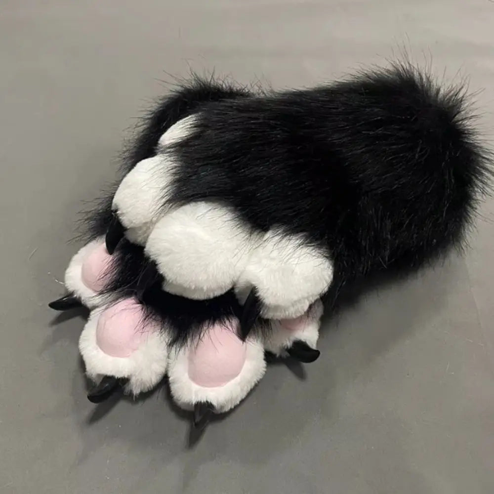 A pair of black and white cartoon cosplay furry gloves with pink accents.