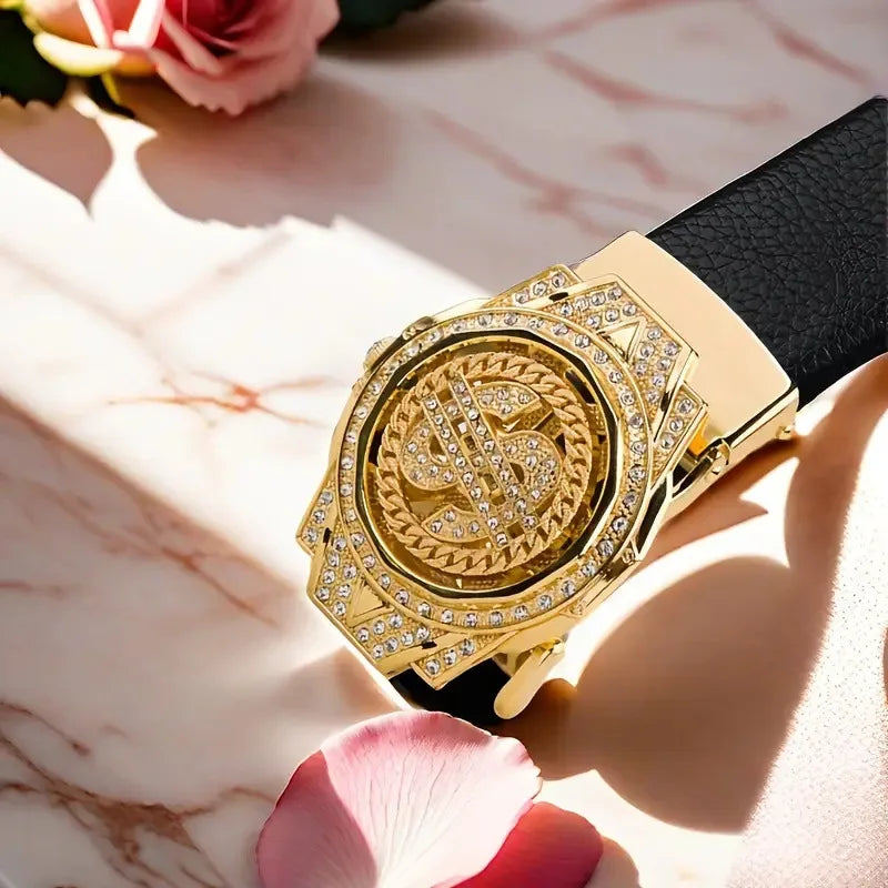 A close-up of a gold-toned watch with a diamond-encrusted face and a black leather strap resting on a pink marble surface.
