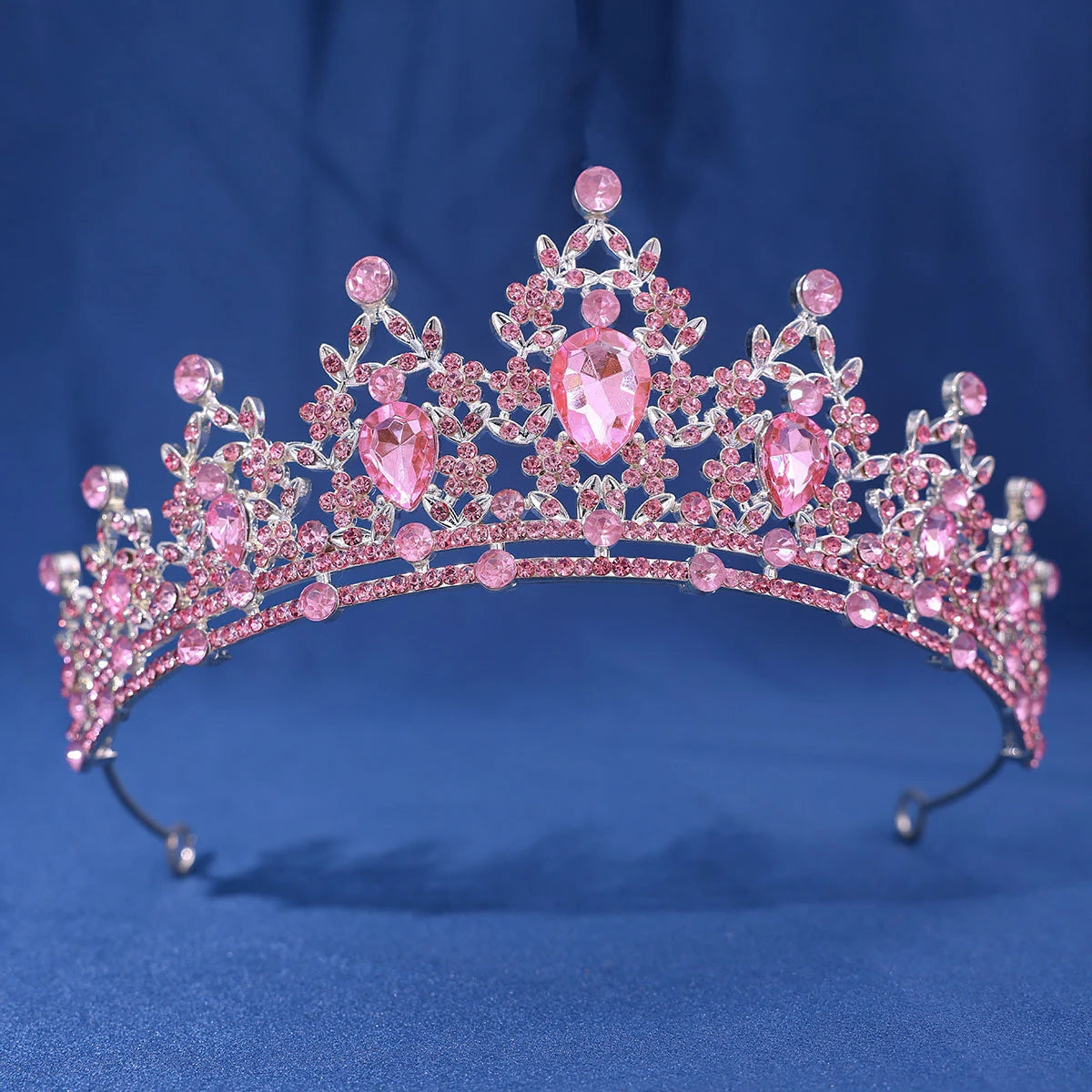 A pink crystal rhinestone tiara and headband set with intricate floral designs.