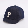 A dark navy denim baseball cap with a light beige letter P embroidered on the front.
