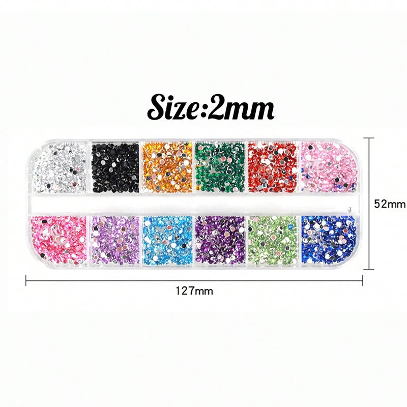 A set of four colored rhinestones for nail art decoration, showing various shades including black, orange, green, and pink.