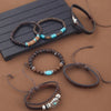 A collection of handcrafted retro western beaded bracelets and leather bands displayed on a dark surface.
