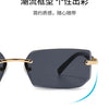 A pair of black rimless rectangle sunglasses with gold accents shown in a close-up view.