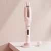 A pink professional automatic curling iron with a vertical design sits on a white surface.