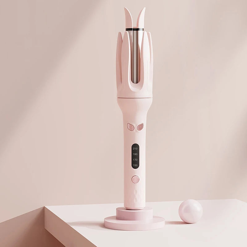A pink professional automatic curling iron with a vertical design sits on a white surface.