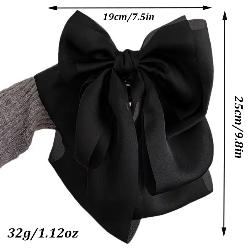 Black satin bow hair clip shown with dimensions and weight.