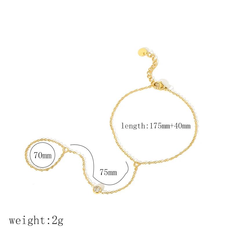 A delicate gold plated stainless steel bracelet featuring a zircon ring design with adjustable length.
