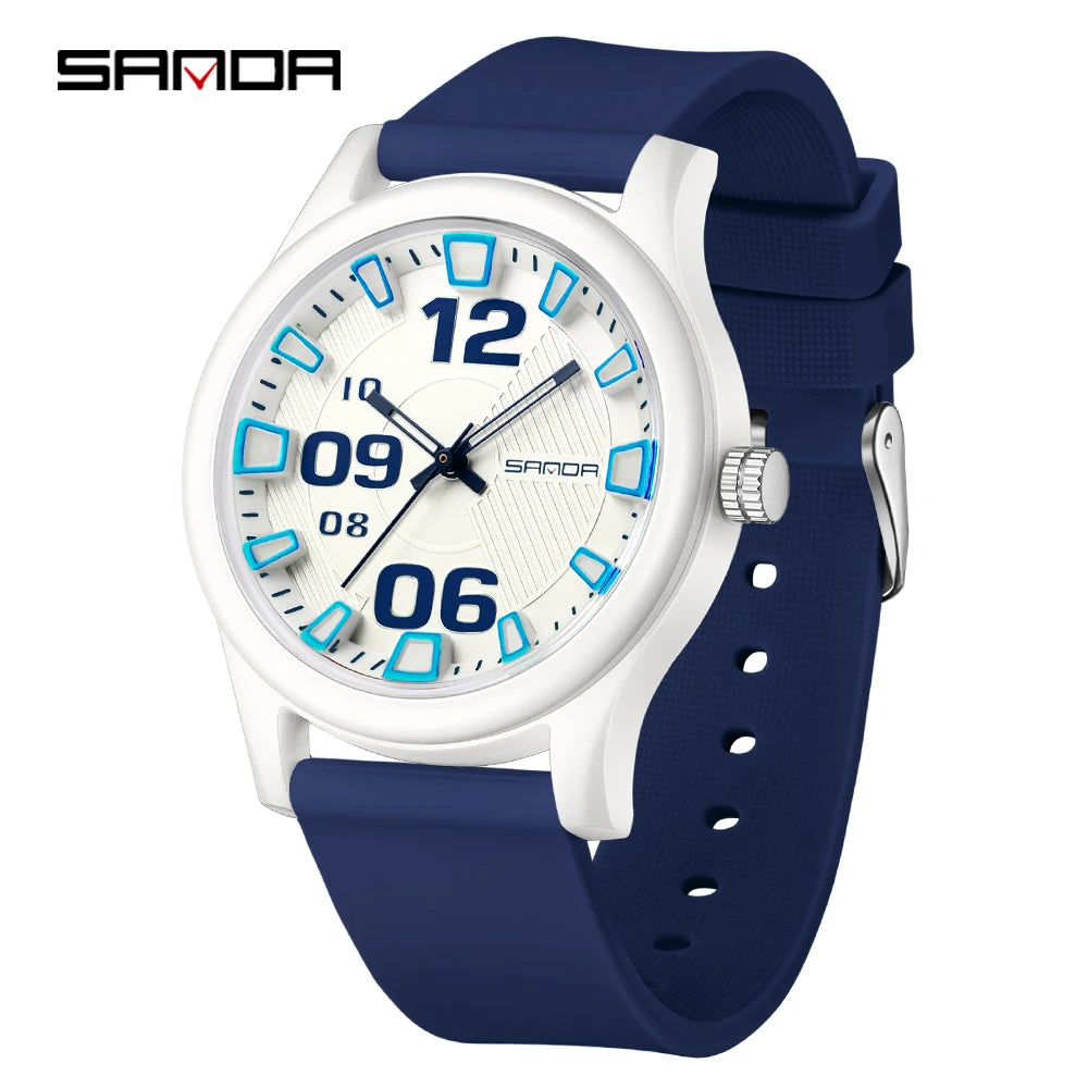 A white and blue digital-style watch with a dark blue silicone strap and silver accents.