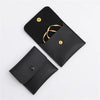 Black elegant PU leather jewelry pouch with a gold chain and snap button